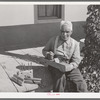 Old Spanish-American farmer with homemade tools. Chamisal, New Mexico