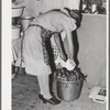 Removing jars of canned fruit from pressure cooker. Chamisal, New Mexico