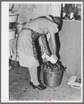 Removing jars of canned fruit from pressure cooker. Chamisal, New Mexico