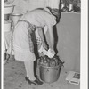 Removing jars of canned fruit from pressure cooker. Chamisal, New Mexico