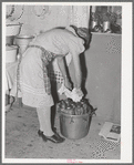 Removing jars of canned fruit from pressure cooker. Chamisal, New Mexico