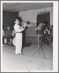 Young Spanish-American musician in traveling show at Penasco, New Mexico. These traveling shows are the main source of entertainment