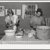 Spanish-American couple preparing fruit for canning. Chamisal, New Mexico