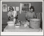 Spanish-American couple preparing fruit for canning. Chamisal, New Mexico