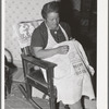 Spanish-American woman doing needlework. Many of the homes in this section show the love of the Spanish-Americans for colorful decoration. Chamisal, New Mexico