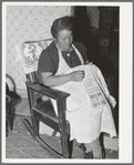 Spanish-American woman doing needlework. Many of the homes in this section show the love of the Spanish-Americans for colorful decoration. Chamisal, New Mexico