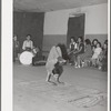 Acrobat and audience at Spanish-American traveling show. Penasco, New Mexico