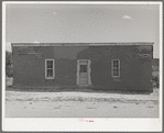 Front of Spanish-American house, Penasco, New Mexico. Notice the small windows, however; because of the brilliant suns in this section, the interiors of the houses are not dark and drab, rather the light seems pleasant and subdued