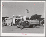 Truck and filling station, Penasco, New Mexico. All supplies come into the town by truck