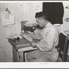 Mr. Keele looks over accounts of the general store. Pie Town, New Mexico