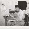 Mr. Keele looks over accounts of the general store. Pie Town, New Mexico