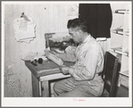 Mr. Keele looks over accounts of the general store. Pie Town, New Mexico