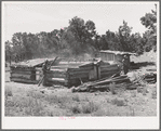 Faro Caudill and neighbor John Adams tearing down dugout. Pie Town, New Mexico