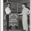 President of the singing convention. He is also a homesteader, on the right presenting the banner to Mr. Whinery as representative of one group of the contesting singers. Pie Town, New Mexico