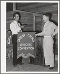 President of the singing convention. He is also a homesteader, on the right presenting the banner to Mr. Whinery as representative of one group of the contesting singers. Pie Town, New Mexico