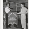 President of the singing convention. He is also a homesteader, on the right presenting the banner to Mr. Whinery as representative of one group of the contesting singers. Pie Town, New Mexico