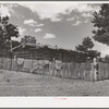 Log house of farmer with a fence of hand-split rails. Pie Town, New Mexico