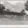Log house of farmer with a fence of hand-split rails. Pie Town, New Mexico