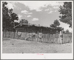 Log house of farmer with a fence of hand-split rails. Pie Town, New Mexico
