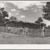 Log house of farmer with a fence of hand-split rails. Pie Town, New Mexico