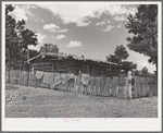 Log house of farmer with a fence of hand-split rails. Pie Town, New Mexico