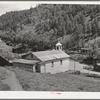Church surrounded by miners' homes. Mogollon, New Mexico