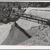 Belt conveyor which drops the tailings onto pile in the valley below. Mill at Mogollon, New Mexico