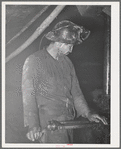Gold miner operating pneumatic drill. Mogollon, New Mexico