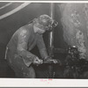 Gold miner operating pneumatic drill at Mogollon, New Mexico