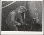 Gold miner operating pneumatic drill at Mogollon, New Mexico
