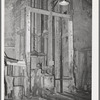 Goldminer pushing car of ore onto hoist. This is elevator to the surface from the 750-feet level. Mogollon, New Mexico