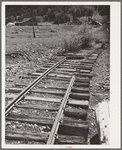 Abandoned railroad leading to abandoned mine. San Juan County, Colorado. When the mines moved out, whole towns and affiliated industries folded up