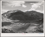Silverton, Colorado lies in a valley at 9400 feet elevation. This has been a center for mining and milling operations and the tailing-choked Animas River can be seen at left