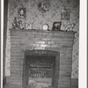 Fireplace in home of farmer living in the Animas River Valley. La Plata County, Colorado