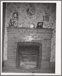 Fireplace in home of farmer living in the Animas River Valley. La Plata County, Colorado