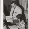 School teacher pointing out a word to grade school pupil, Santa Clara, Utah