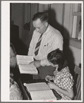 School teacher pointing out a word to grade school pupil, Santa Clara, Utah