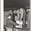 Loading fruit into truck for shipment at produce company warehouse. Santa Clara, Utah