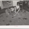 Children of Mormon farmer playing marbles in the living room. Santa Clara, Utah