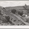 Three roads used in the development of the community of Santa Clara, Utah. The oldest one is barely discernable at the left; the middle one of medium age is still used to reach some farm land; new highway is seen through the trees