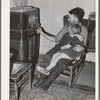 John Frost and daughter listening to radio in their home. Tehama County, California