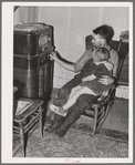 John Frost and daughter listening to radio in their home. Tehama County, California