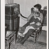 John Frost and daughter listening to radio in their home. Tehama County, California