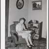 Wife of Elof Hansen in living room of her farm home. He is a small farmer in Yuba County, California