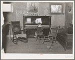 Living room in farm home of John Frost, part owner of 135 acres of semi-marginal land in Tehama County, California. He raises turkeys, hogs and dairy cattle