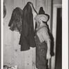 John Frost, farmer in Tehama County, California, donning his work overcoat