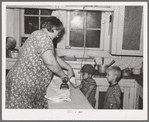 Mrs. J. Webster ironing while her sons look on. Tehama County, California