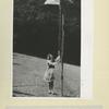 A Po[l]ish girl in a national costume hoists the flag in the Polish Camp for girls in Gronebic, unoccupied France, 1941.