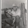 Sheepherder rolling a cigarette. Cimarron, Colorado