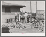 Distributing newspapers to newsboys at the railroad station. Montrose, Colorado